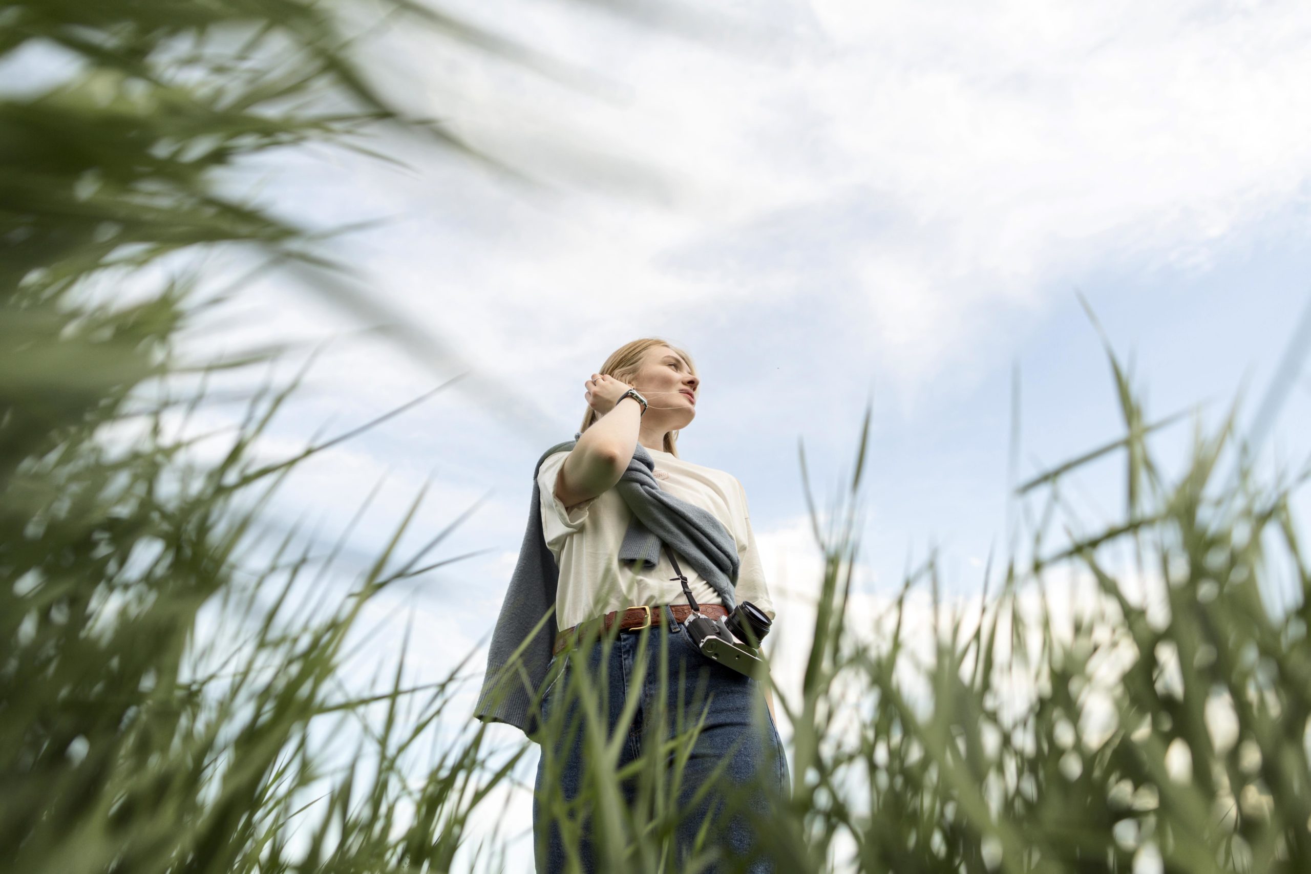 low-angle-woman-posing-with-grass
